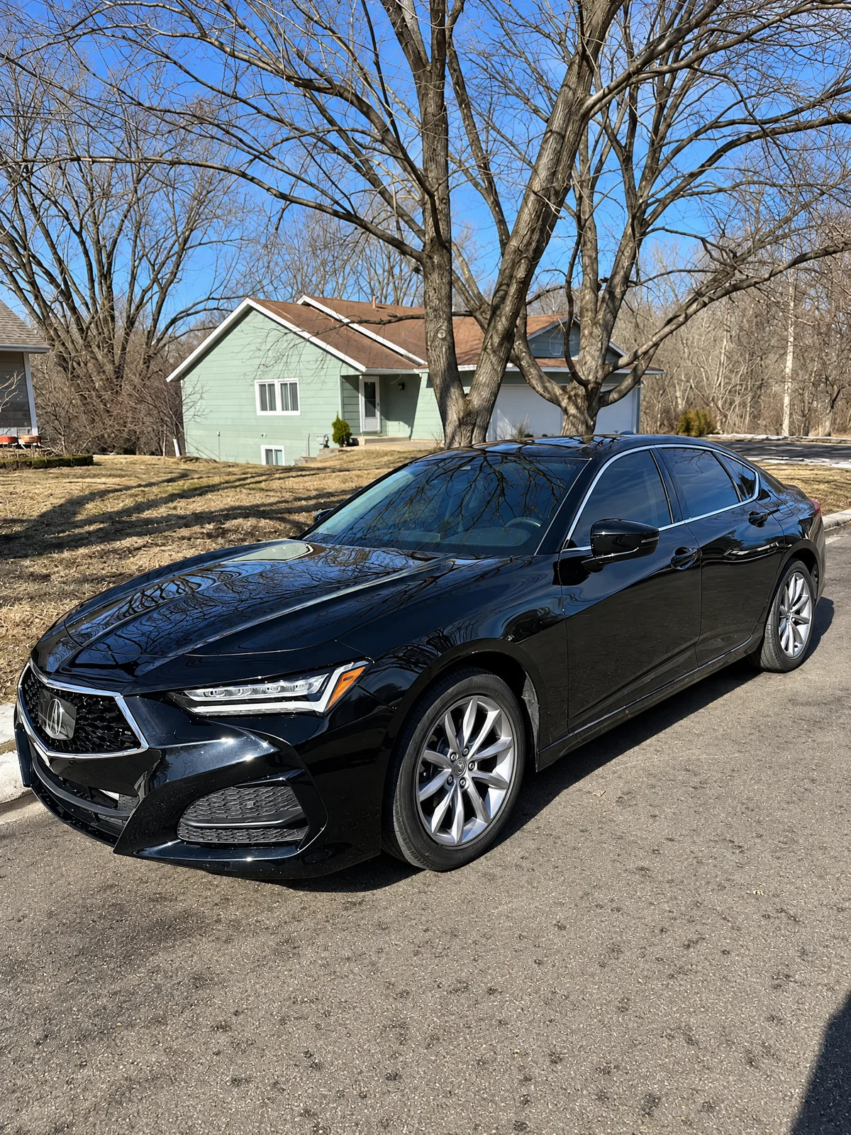 Black Acura TLX with tinted windows