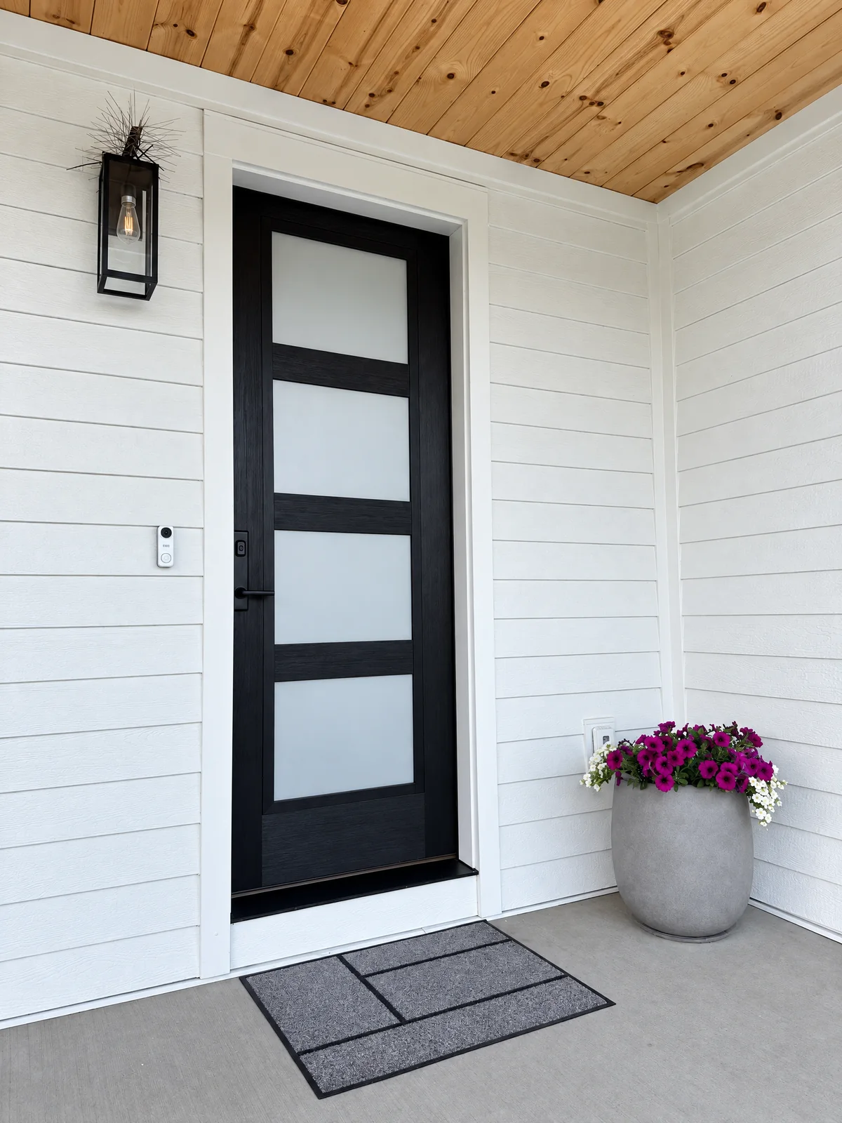 Black front door with frosted film on its glass panels