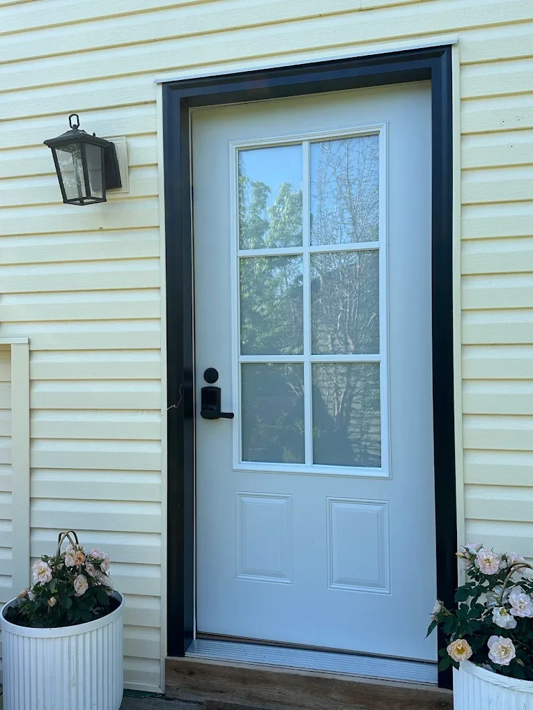 White front door with film on its glass