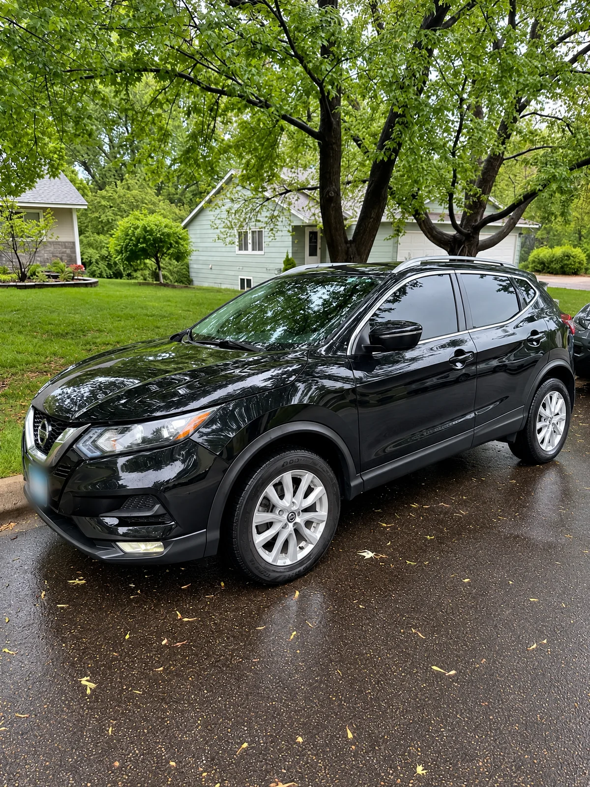 Black Nissan Rogue Sport with tinted windows